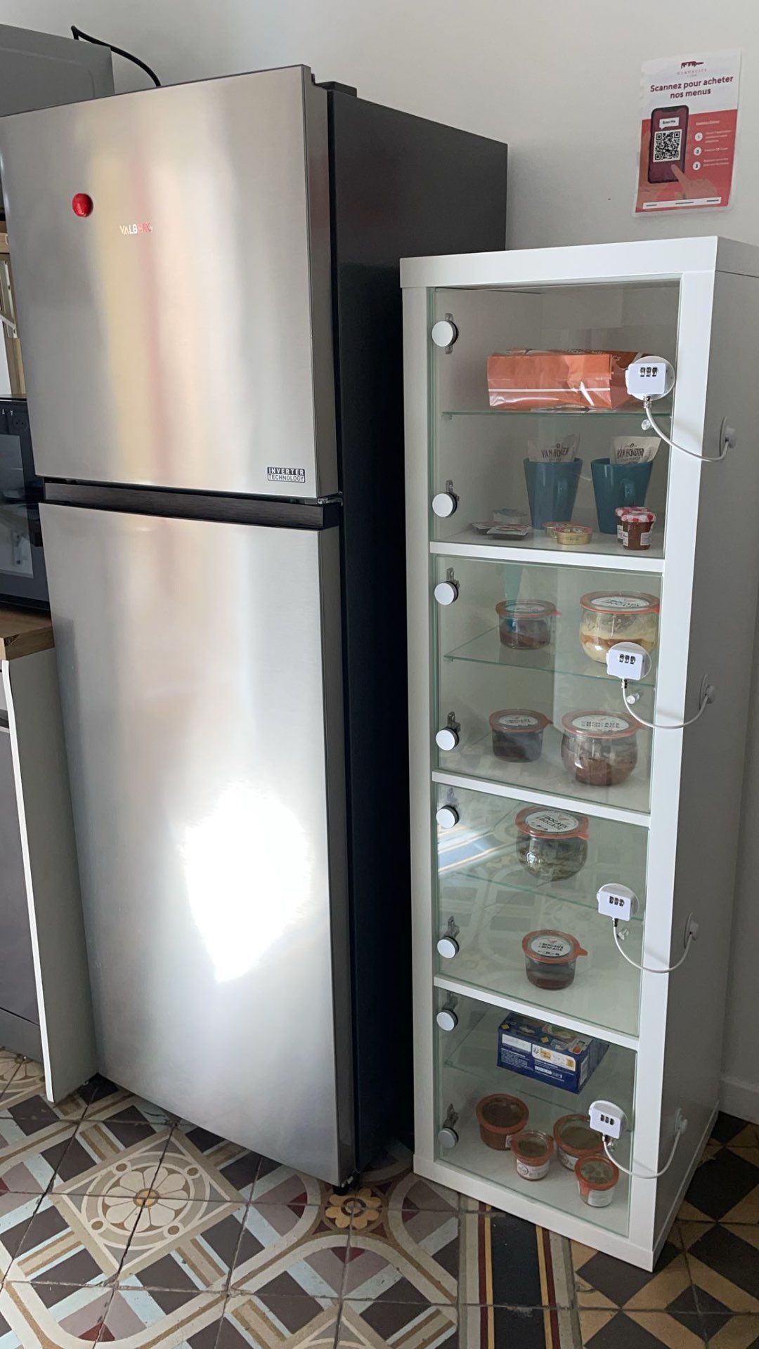 Glass-front bookcase with QR codes for selling local products and specialties